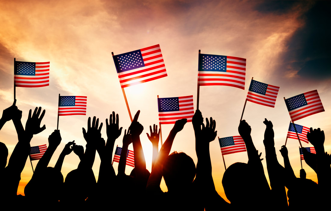 group people waving american flags back lit orig