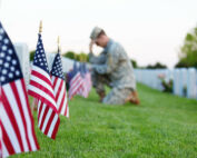 Soldier kneeling at grave