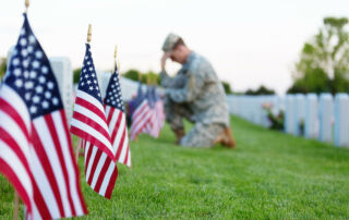 Soldier kneeling at grave